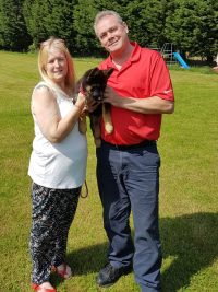 A photograph of the dog trainer collecting his puppy Lexi A photograph of the dog trainer collecting his puppy Lexi